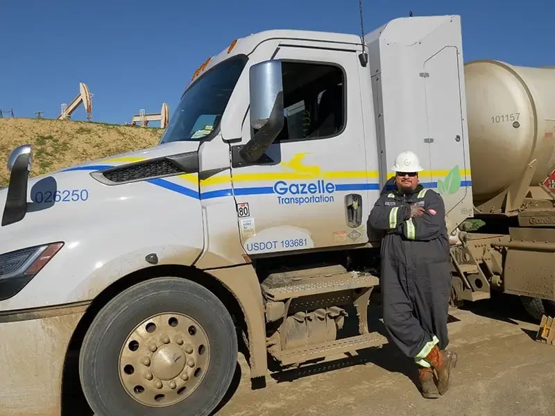 Gazelle driver standing in front of truck