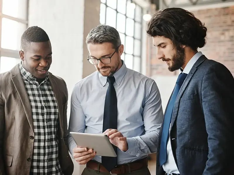 Gazelle workers watching information on a tablet.