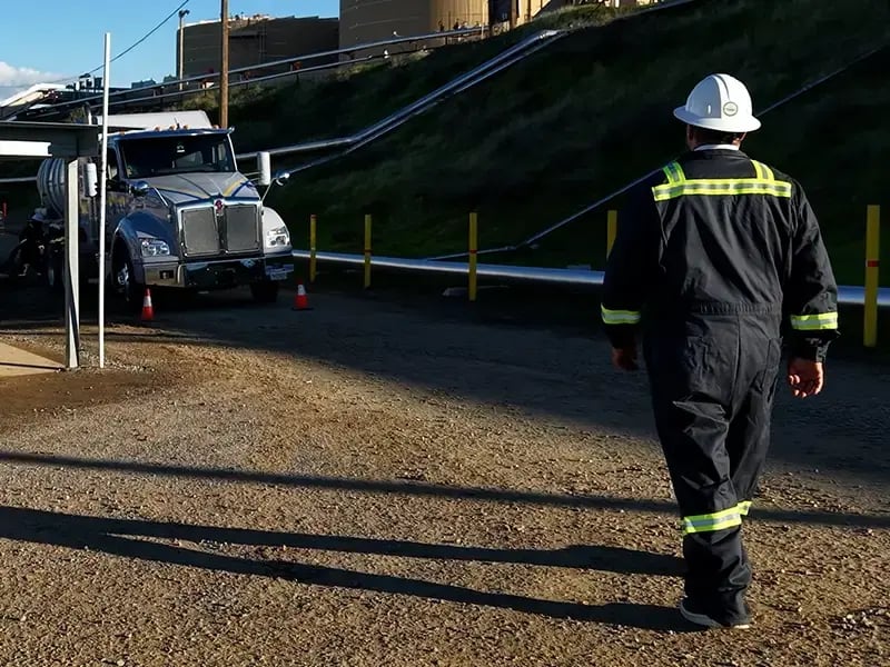 Gazelle safety worker walking towards a truck.
