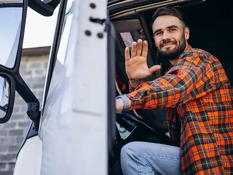 Gazelle truck driver waving from inside the cab.