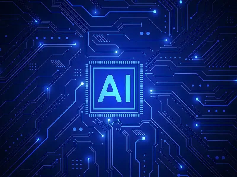 Artificial intelligence icon in the center of a blue circuit board pattern.