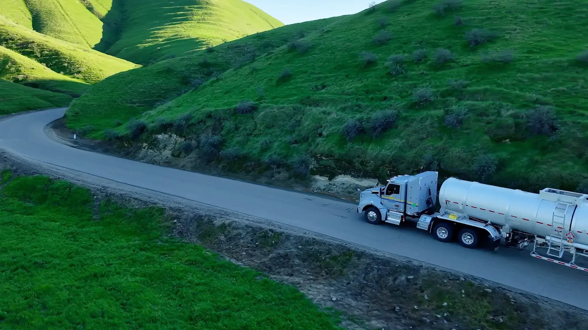 Gallery Gazelle tanker truck on the road green hills.