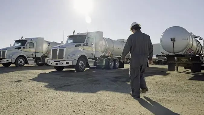 Truck driver walking towards Gazelle tanker trucks.